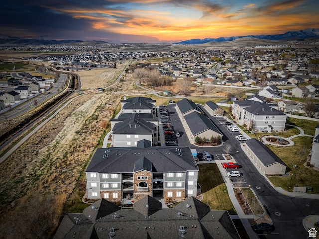 aerial view of property and surrounding area with mountains and nearby suburban area