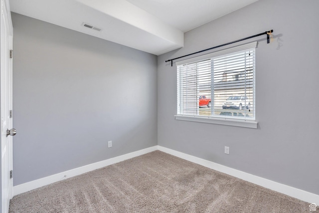 unfurnished room with carpet and baseboards