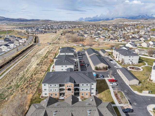 aerial overview of property's location featuring nearby suburban area and a mountain backdrop