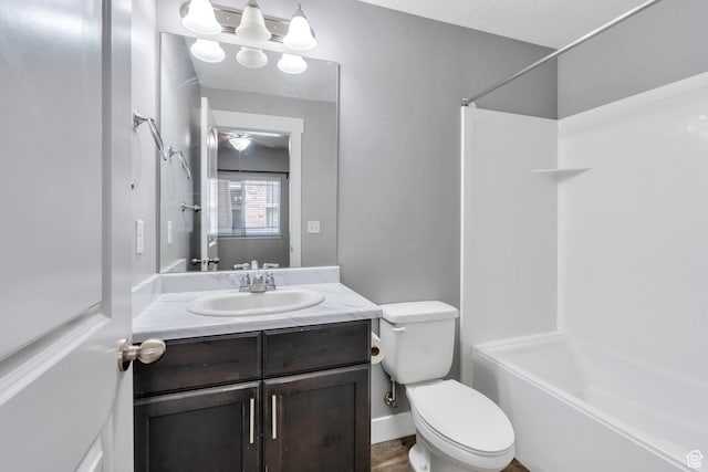 bathroom with toilet,  shower combination, and vanity