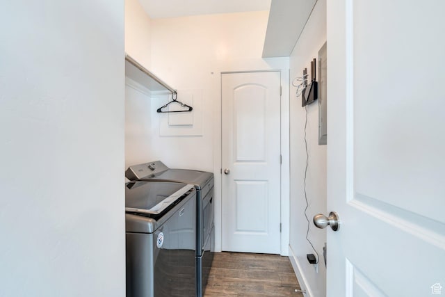 laundry area with separate washer and dryer and dark wood finished floors