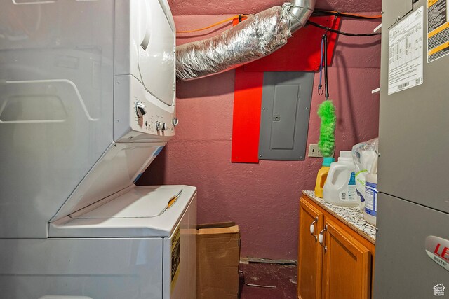 20161 W 5000 S, Duchesne, UT 84021 - laundry room with stacked washer / dryer, a textured wall, cabinet space, and electric panel