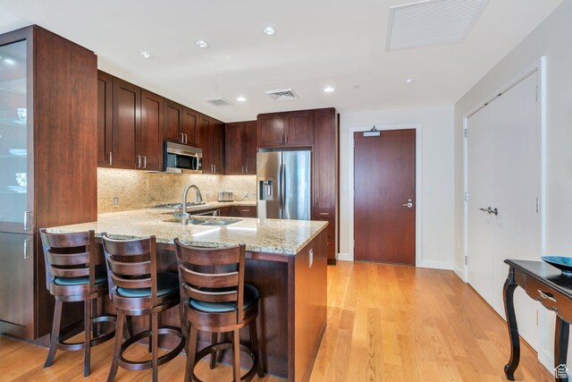 45 W S Temple Unit 603, Salt Lake City, UT 84101 - kitchen with a sink, visible vents, stainless steel appliances, and light wood-type flooring