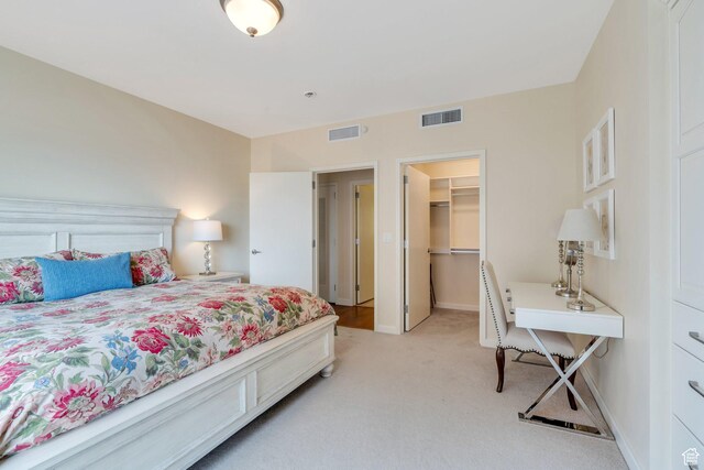 45 W S Temple Unit 603, Salt Lake City, UT 84101 - bedroom featuring baseboards, visible vents, a spacious closet, and light carpet