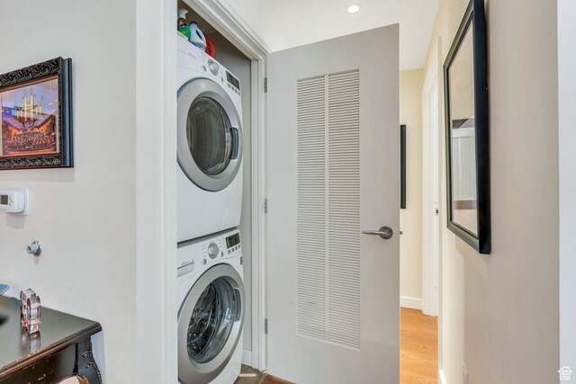 45 W S Temple Unit 603, Salt Lake City, UT 84101 - laundry area featuring stacked washer / dryer, light wood-style flooring, baseboards, and laundry area