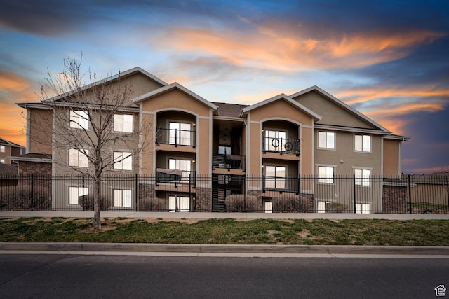 view of front of house with a fenced front yard and stucco siding