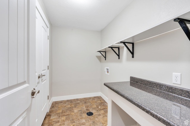 spacious closet with stone finish floors