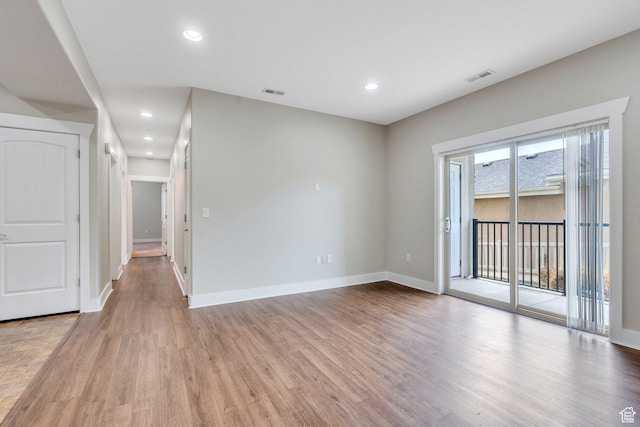 empty room featuring light wood-style flooring, baseboards, and recessed lighting