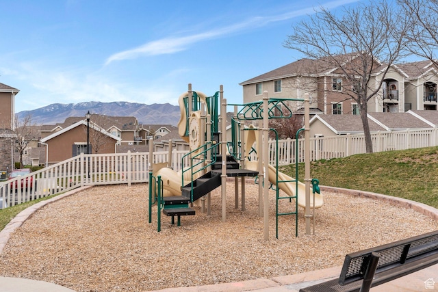 community playground with a residential view and a mountain view