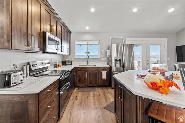 14440 N 11740 E, Mount Pleasant, UT 84647 - kitchen with stainless steel appliances, french doors, a sink, light wood finished floors, and recessed lighting