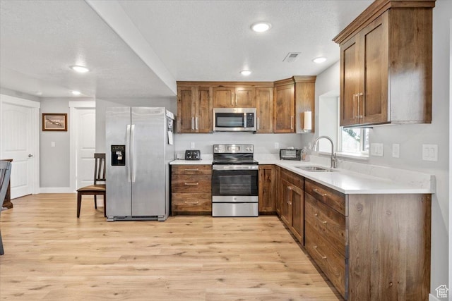 14440 N 11740 E, Mount Pleasant, UT 84647 - kitchen featuring stainless steel appliances, a sink, recessed lighting, light wood-type flooring, and light countertops