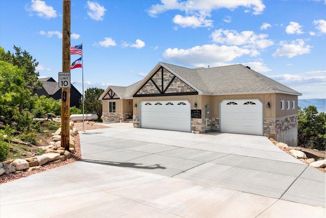 14440 N 11740 E, Mount Pleasant, UT 84647 - view of front facade with stone siding, a garage, concrete driveway, and a shingled roof