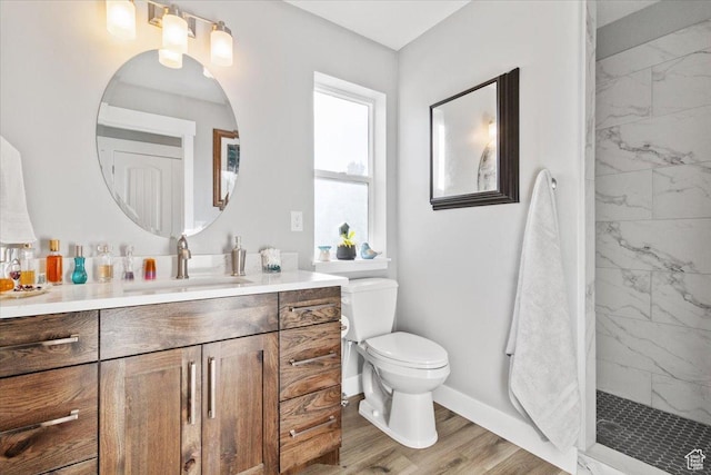 14440 N 11740 E, Mount Pleasant, UT 84647 - bathroom featuring vanity, baseboards, toilet, a marble finish shower, and wood finished floors