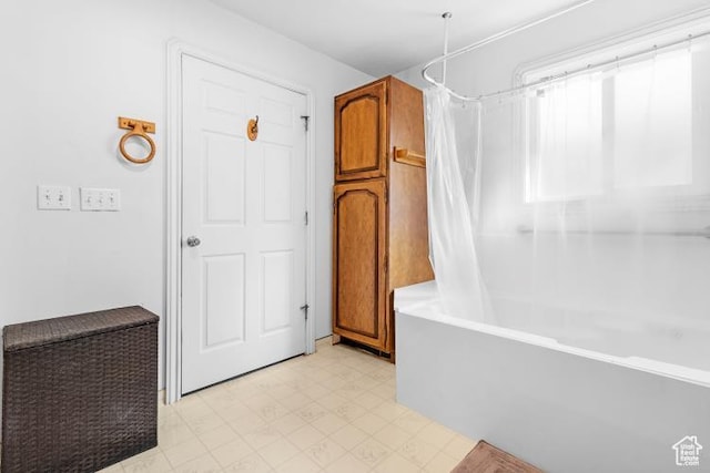 bathroom featuring tile patterned floors and shower / tub combo
