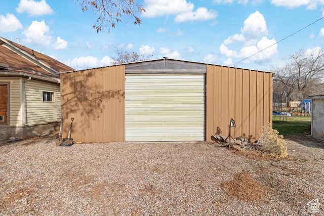 detached garage featuring dirt driveway
