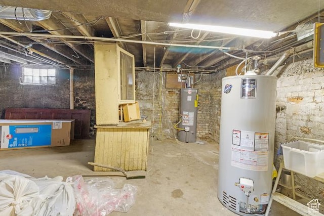 basement with water heater and gas water heater