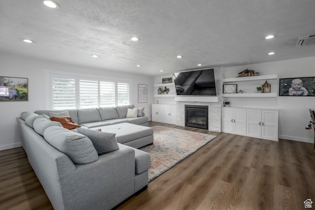 1155 E 300 N, American Fork, UT 84003 - living room with wood finished floors, a glass covered fireplace, visible vents, and recessed lighting