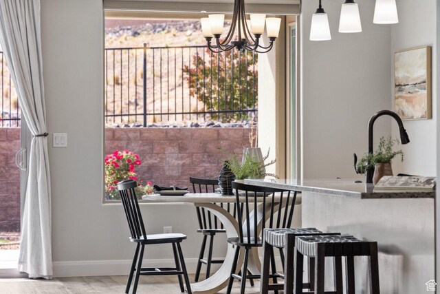 1867 W Grapevine, Hurricane, UT 84737 - dining space with baseboards, a chandelier, and wood finished floors