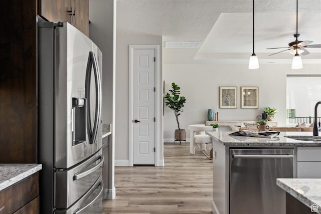 1867 W Grapevine, Hurricane, UT 84737 - kitchen with appliances with stainless steel finishes, a sink, light wood-style flooring, ceiling fan, and dark brown cabinets