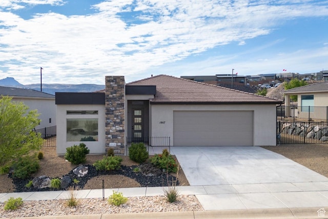 1867 W Grapevine, Hurricane, UT 84737 - modern home featuring fence, stucco siding, an attached garage, and concrete driveway