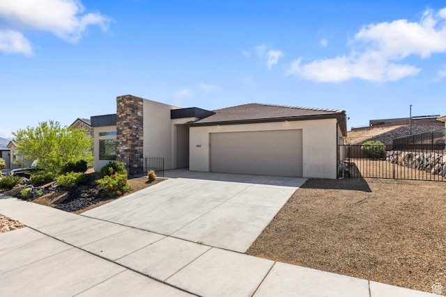 1867 W Grapevine, Hurricane, UT 84737 - view of front of home with stucco siding, fence, concrete driveway, an attached garage, and a tiled roof