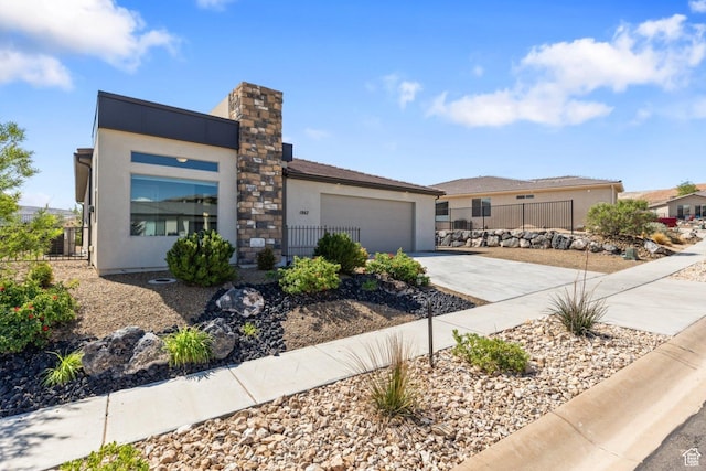 1867 W Grapevine, Hurricane, UT 84737 - view of front of house with concrete driveway, stucco siding, a garage, and fence