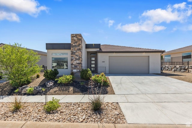1867 W Grapevine, Hurricane, UT 84737 - view of front facade with stucco siding, driveway, a garage, and fence