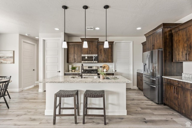 1867 W Grapevine, Hurricane, UT 84737 - kitchen featuring stainless steel appliances, a sink, light wood-style flooring, dark brown cabinets, and baseboards