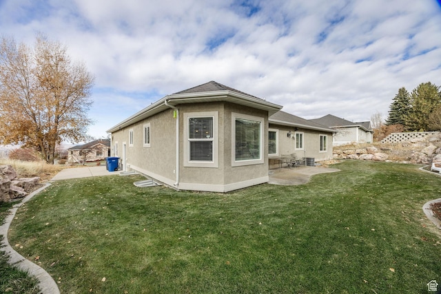 240 Bugle Way, Providence, UT 84332 - rear view of property featuring a lawn, stucco siding, and a patio area