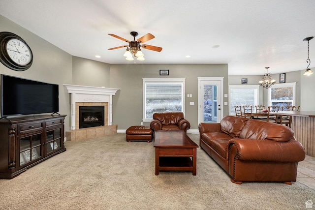 240 Bugle Way, Providence, UT 84332 - living room with a tile fireplace, plenty of natural light, carpet, and ceiling fan with notable chandelier