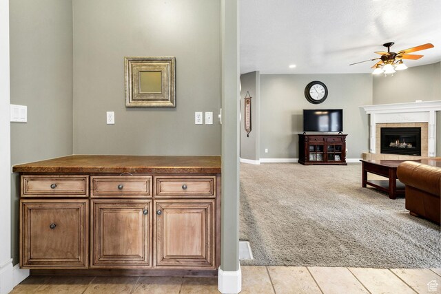 240 Bugle Way, Providence, UT 84332 - living area with light colored carpet, a tile fireplace, baseboards, and a ceiling fan