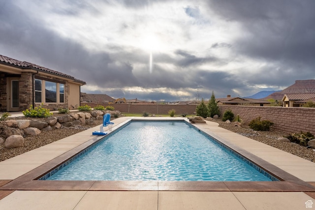 view of swimming pool featuring a fenced in pool and a fenced backyard