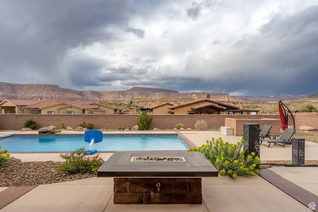 view of pool with a patio, a mountain view, fence, and a fenced in pool