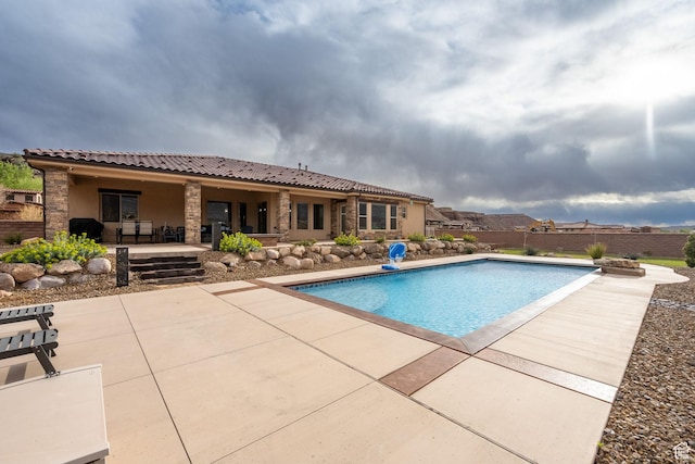 view of swimming pool featuring fence, a patio, and a fenced in pool