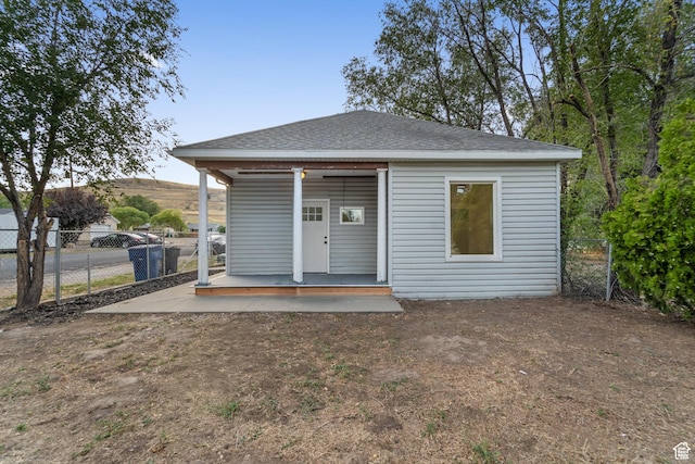 2814 S 9100 W, Magna, UT 84044 - rear view of property with roof with shingles and a porch
