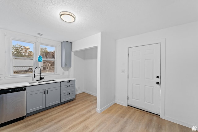 2814 S 9100 W, Magna, UT 84044 - kitchen featuring stainless steel dishwasher, gray cabinetry, a sink, a textured ceiling, and light wood-type flooring
