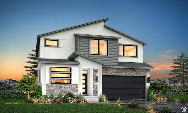 modern home featuring driveway, stucco siding, an attached garage, and stone siding
