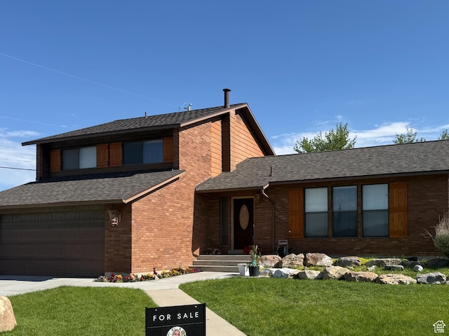 120 E Deseret Cir, Grantsville, UT 84029 - view of front of house with brick siding, an attached garage, and a front yard