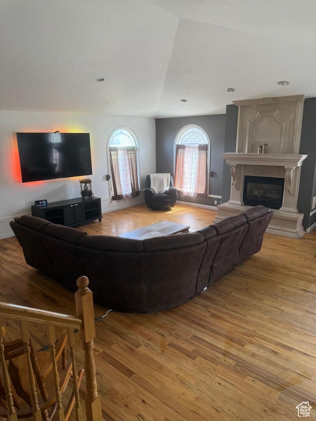 120 E Deseret Cir, Grantsville, UT 84029 - living area featuring light wood-style floors, a large fireplace, and baseboards