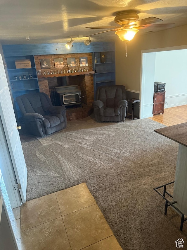 120 E Deseret Cir, Grantsville, UT 84029 - living area featuring a wood stove, a ceiling fan, and rail lighting