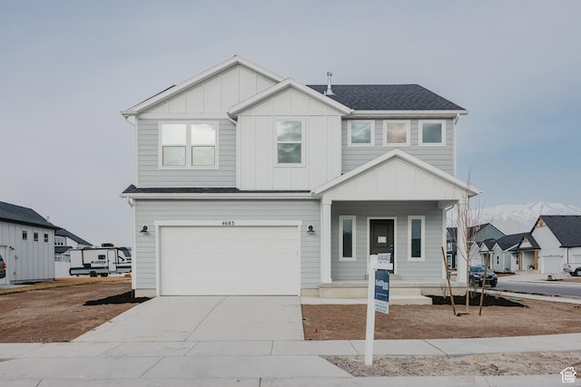 view of front of property featuring a garage, concrete driveway, board and batten siding, covered porch, and a shingled roof