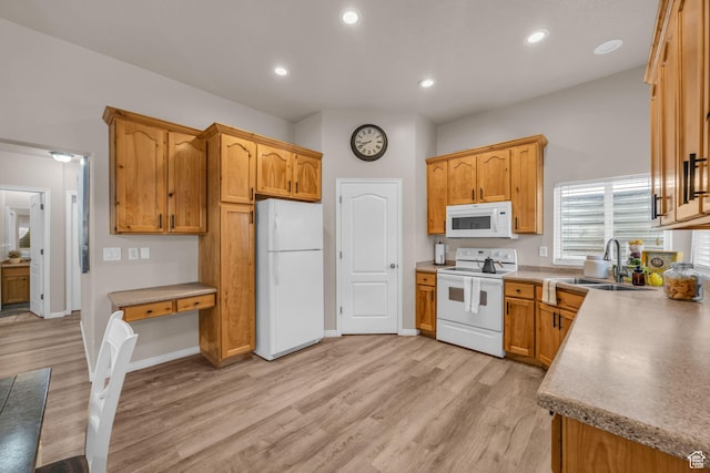 kitchen with recessed lighting, a sink, light wood-style floors, and white appliances