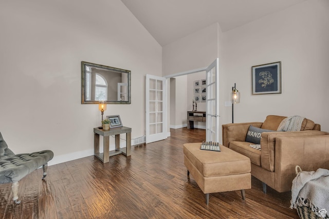 living room with french doors, high vaulted ceiling, baseboards, and wood finished floors
