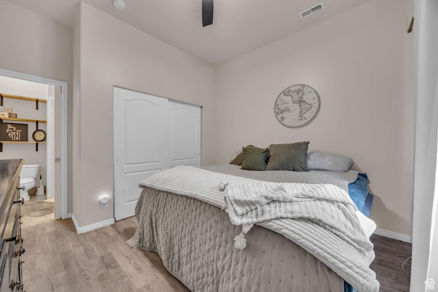 bedroom with baseboards, visible vents, and light wood-type flooring