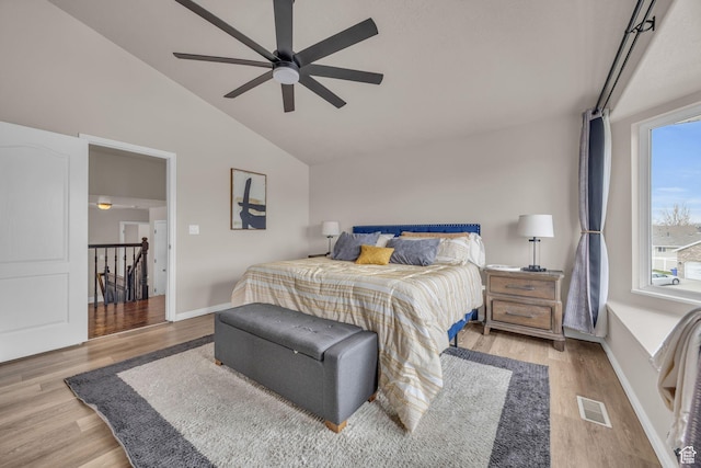 bedroom with vaulted ceiling, baseboards, visible vents, a ceiling fan, and wood finished floors