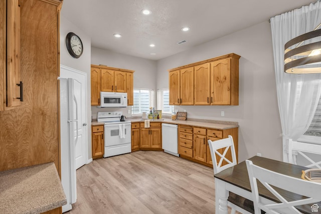 kitchen with light countertops, recessed lighting, white appliances, light wood finished floors, and visible vents