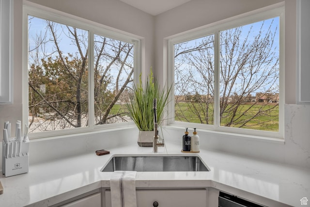 room details with white cabinetry and light countertops