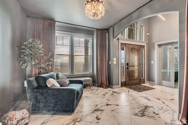 692 N Harrison Blvd, Ogden, UT 84404 - foyer entrance with arched walkways, a chandelier, marble tiled floors, and baseboards