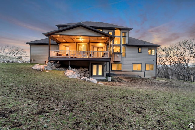 692 N Harrison Blvd, Ogden, UT 84404 - rear view of property featuring a yard, a deck, and a shingled roof