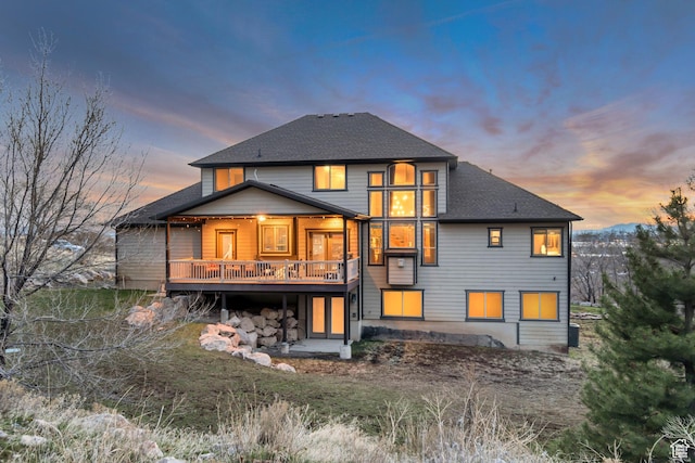 692 N Harrison Blvd, Ogden, UT 84404 - back of house at dusk featuring roof with shingles and a deck